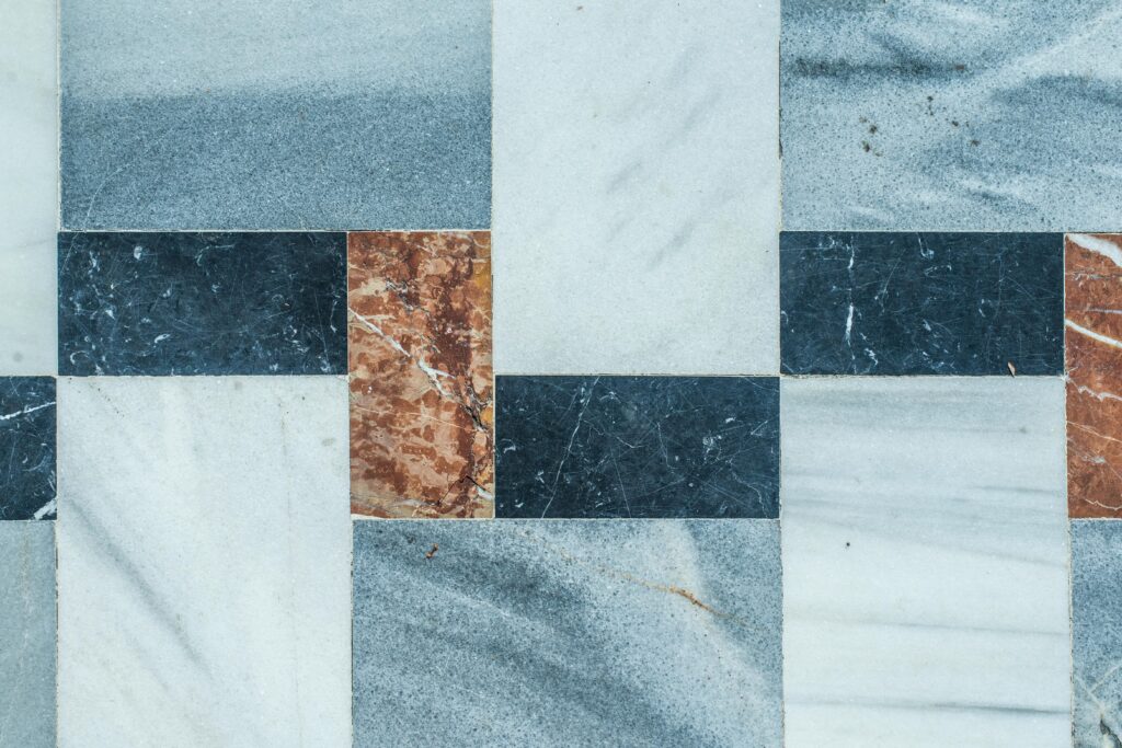 pexels photo 1652544 1652544 Close-up of a geometric marble tile pattern with natural texture colors.
